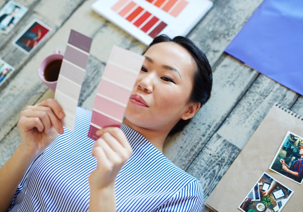 Girl looking at color swatches and choosing between them