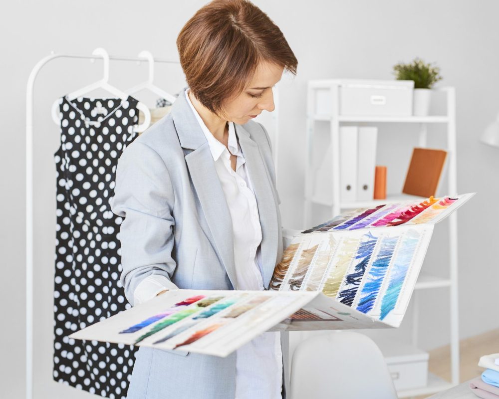 side-view-female-fashion-designer-consulting-color-palette-clothing-line